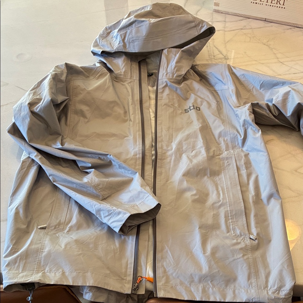Stio Men's Hooded Rollick Gray Rain Jacket.